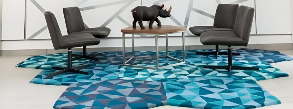 Shaped rug in hues of blue within a lounge setting
