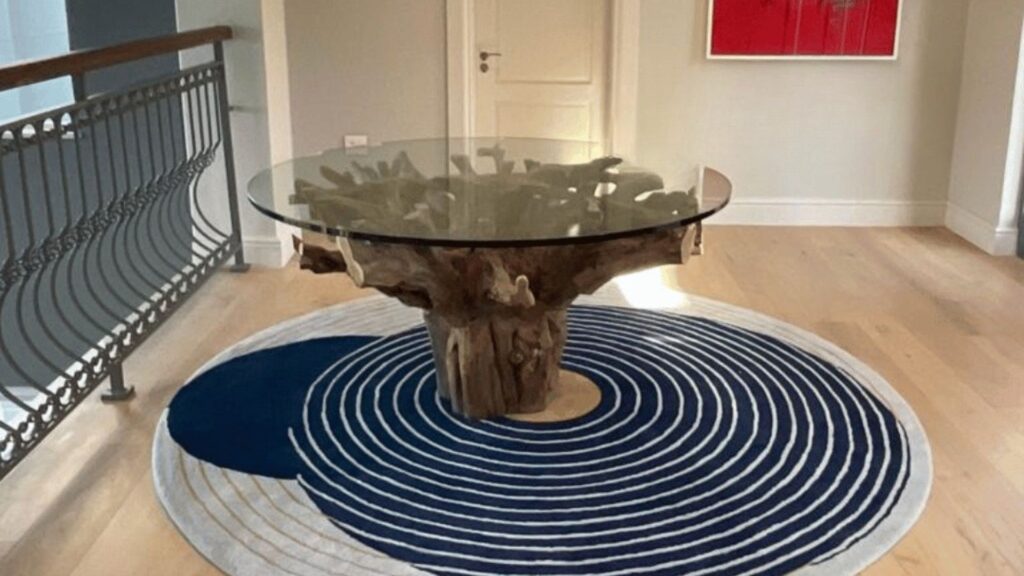 circular rug with dark blue and grey line detail placed at an entrance way